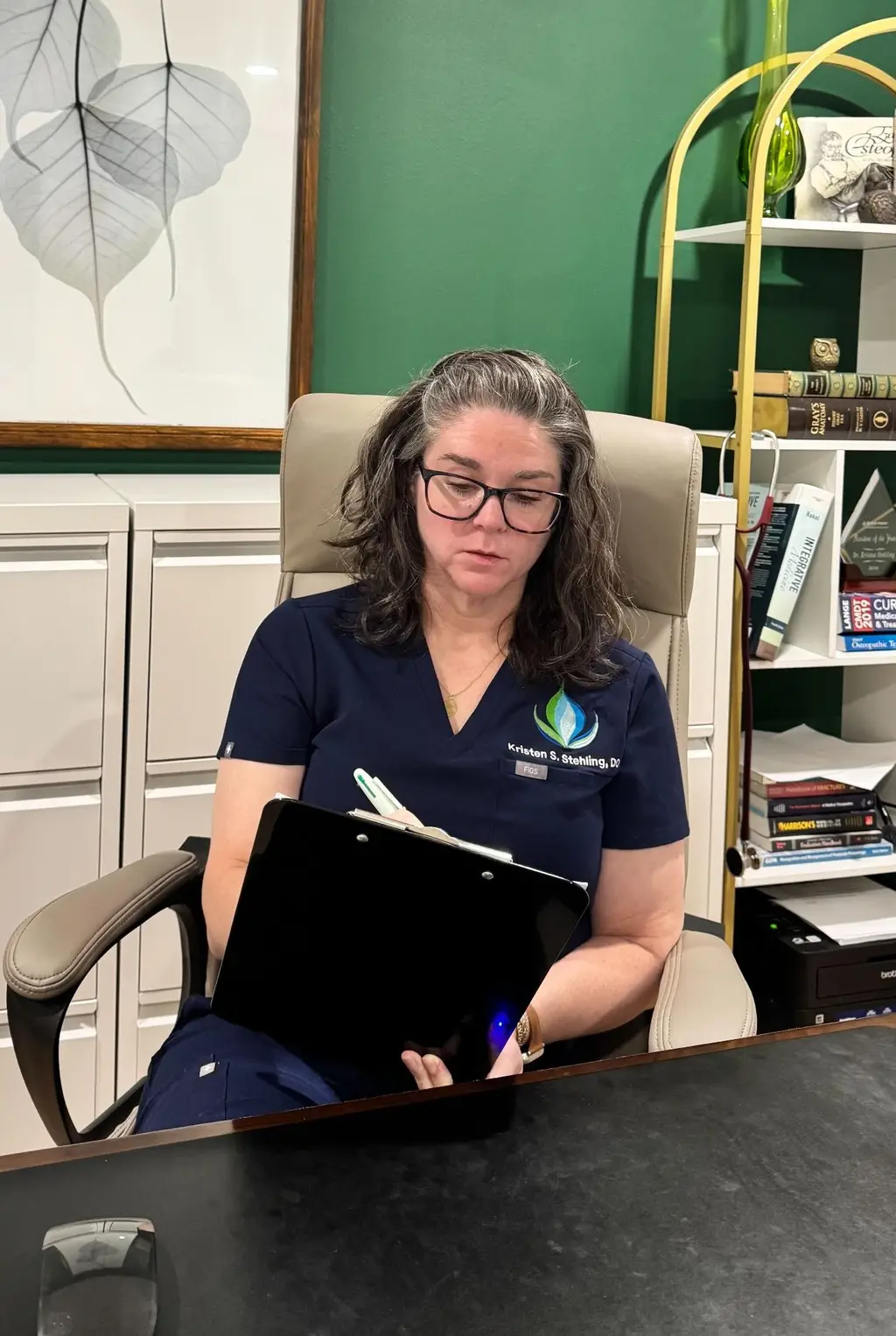 Independent physician reviewing practice operations at a desk